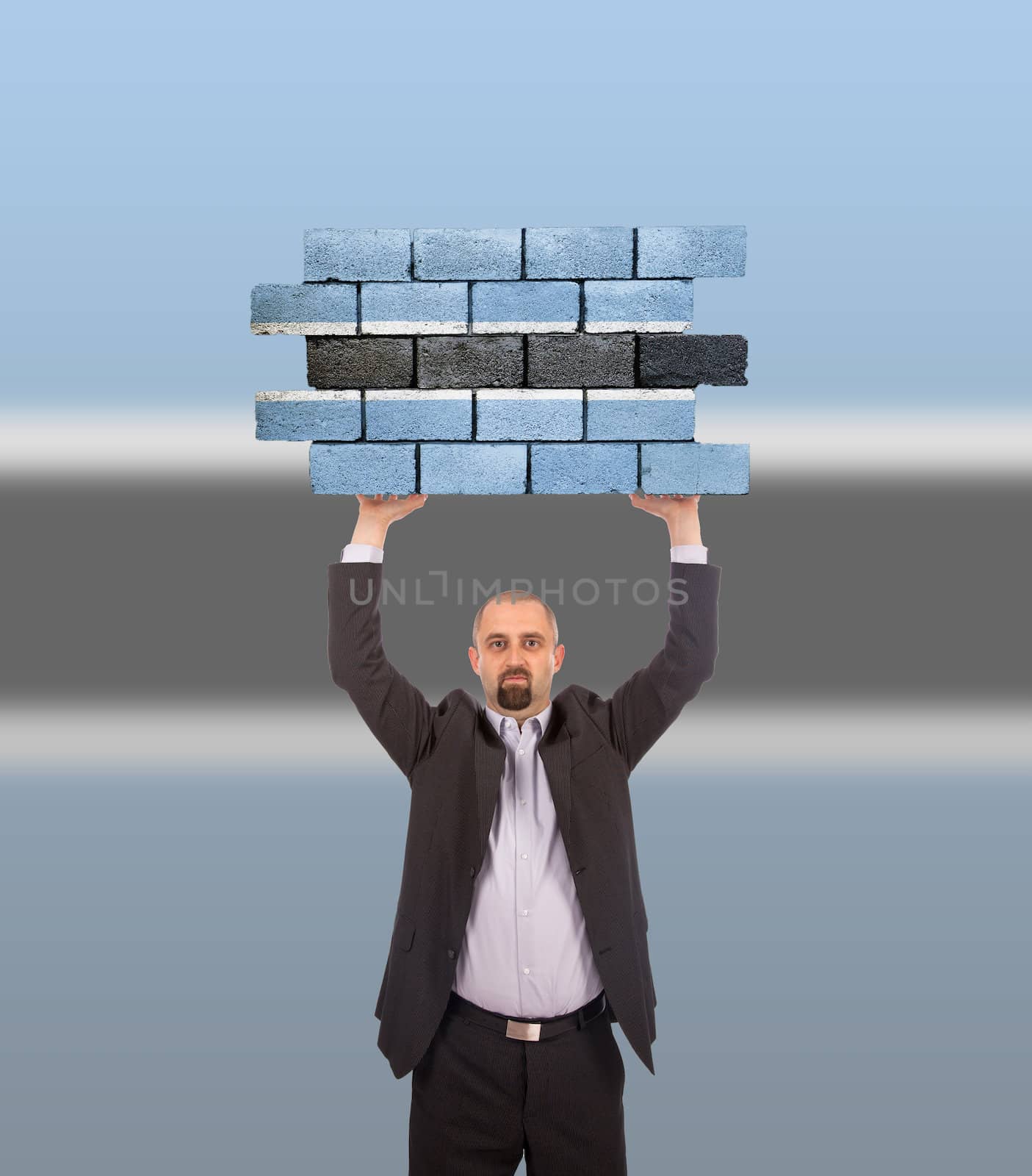 Businessman holding a large piece of a brick wall by michaklootwijk