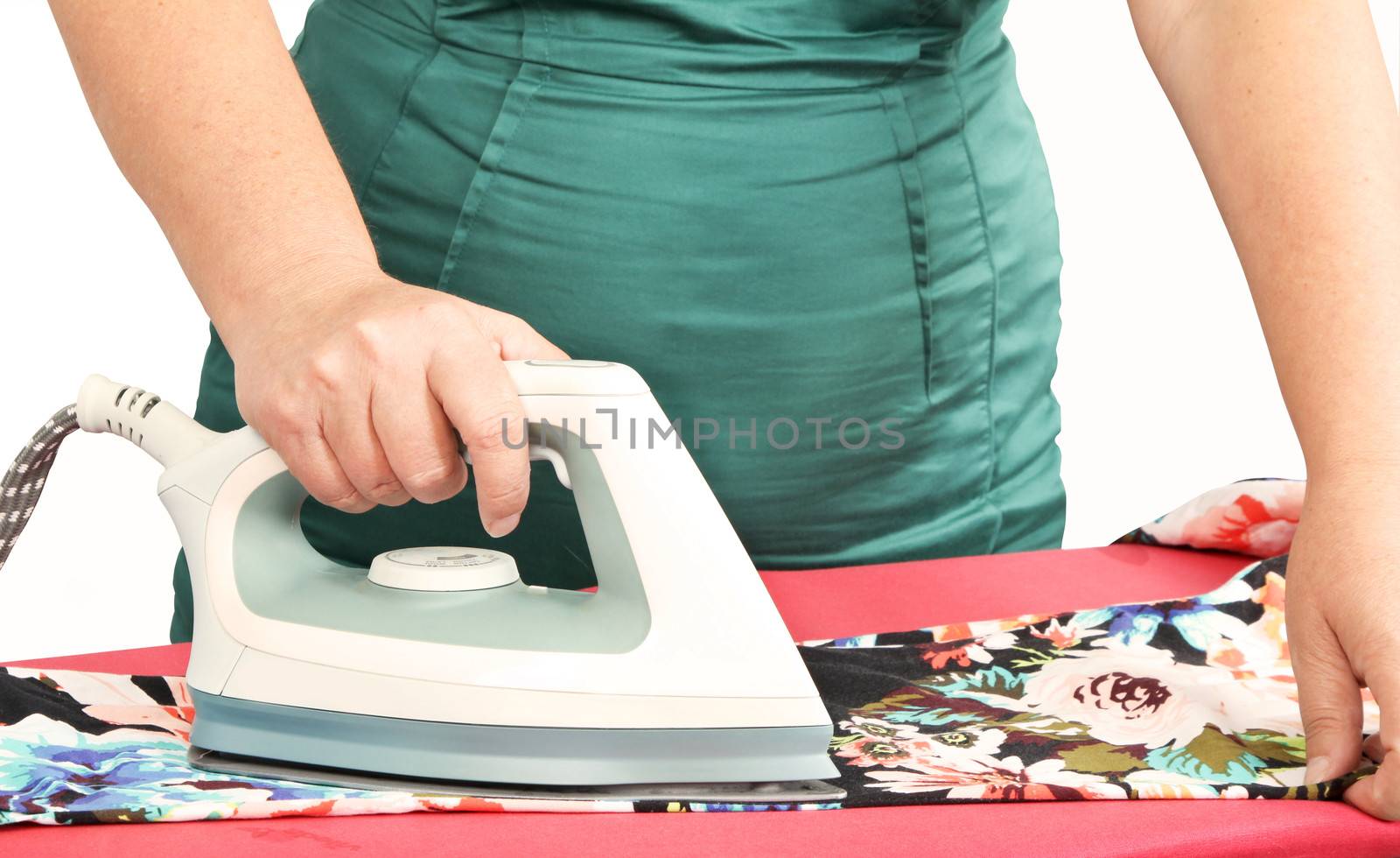 woman ironing clothes on ironing board