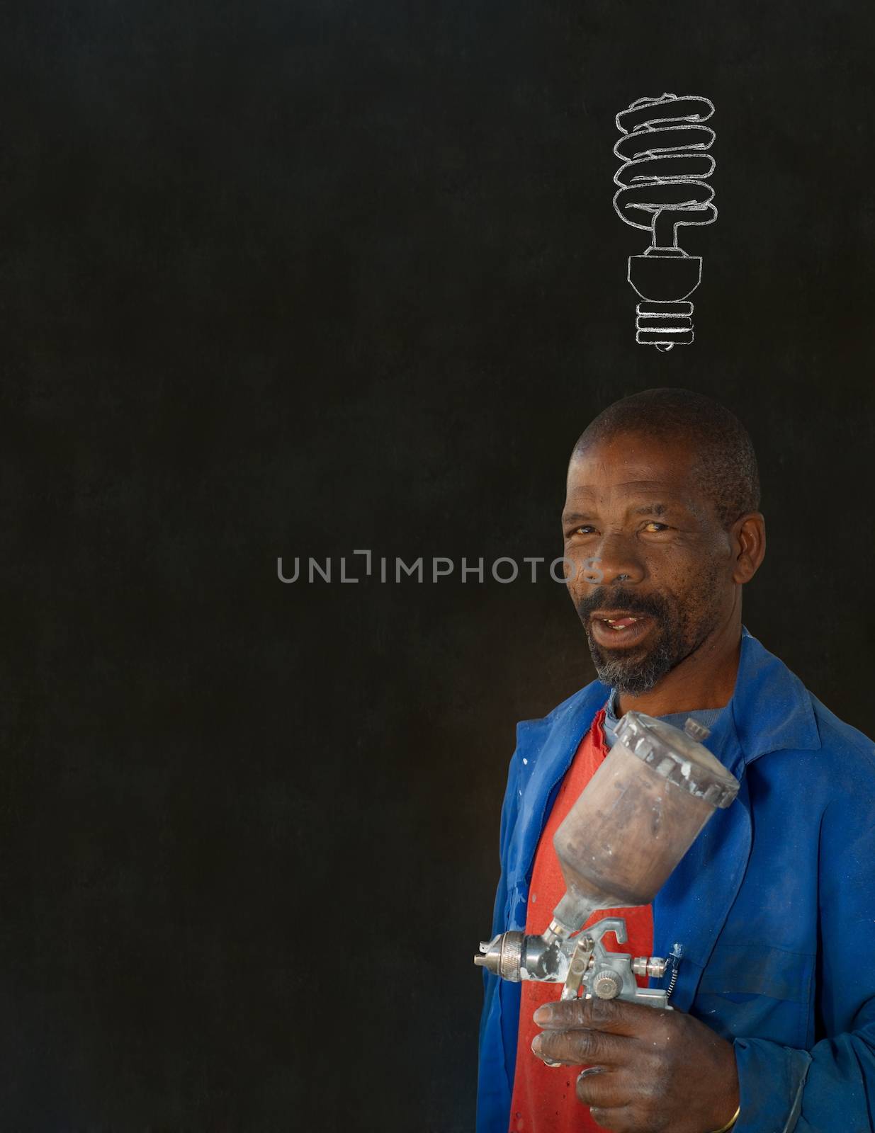 African or American black man industrial worker with chalk energy saving lightbulb on blackboard background