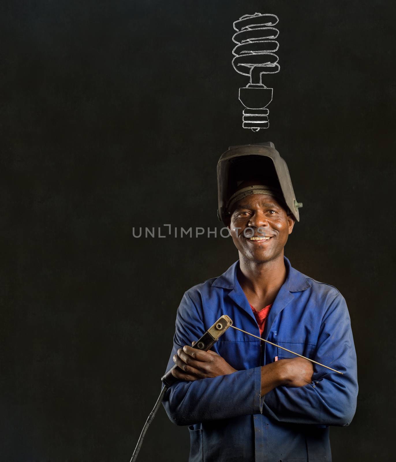 African black man industrial worker with energy saving lightbulb blackboard by alistaircotton