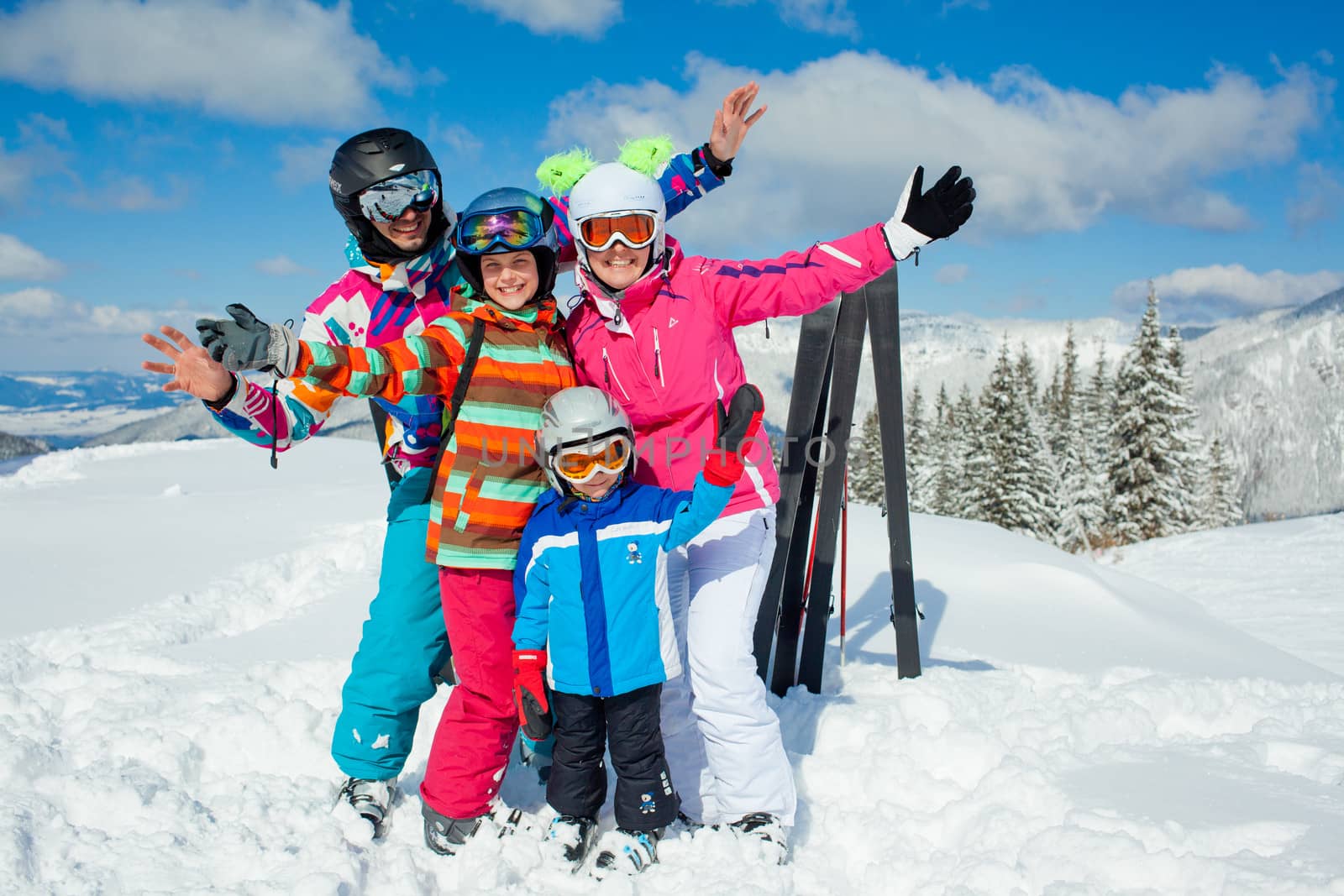 Skiing, winter, snow, sun and fun - family enjoying winter vacations