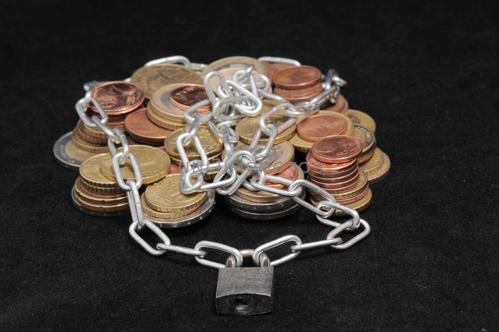 Secure Savings - a Lock and Some Coins on a Black Background