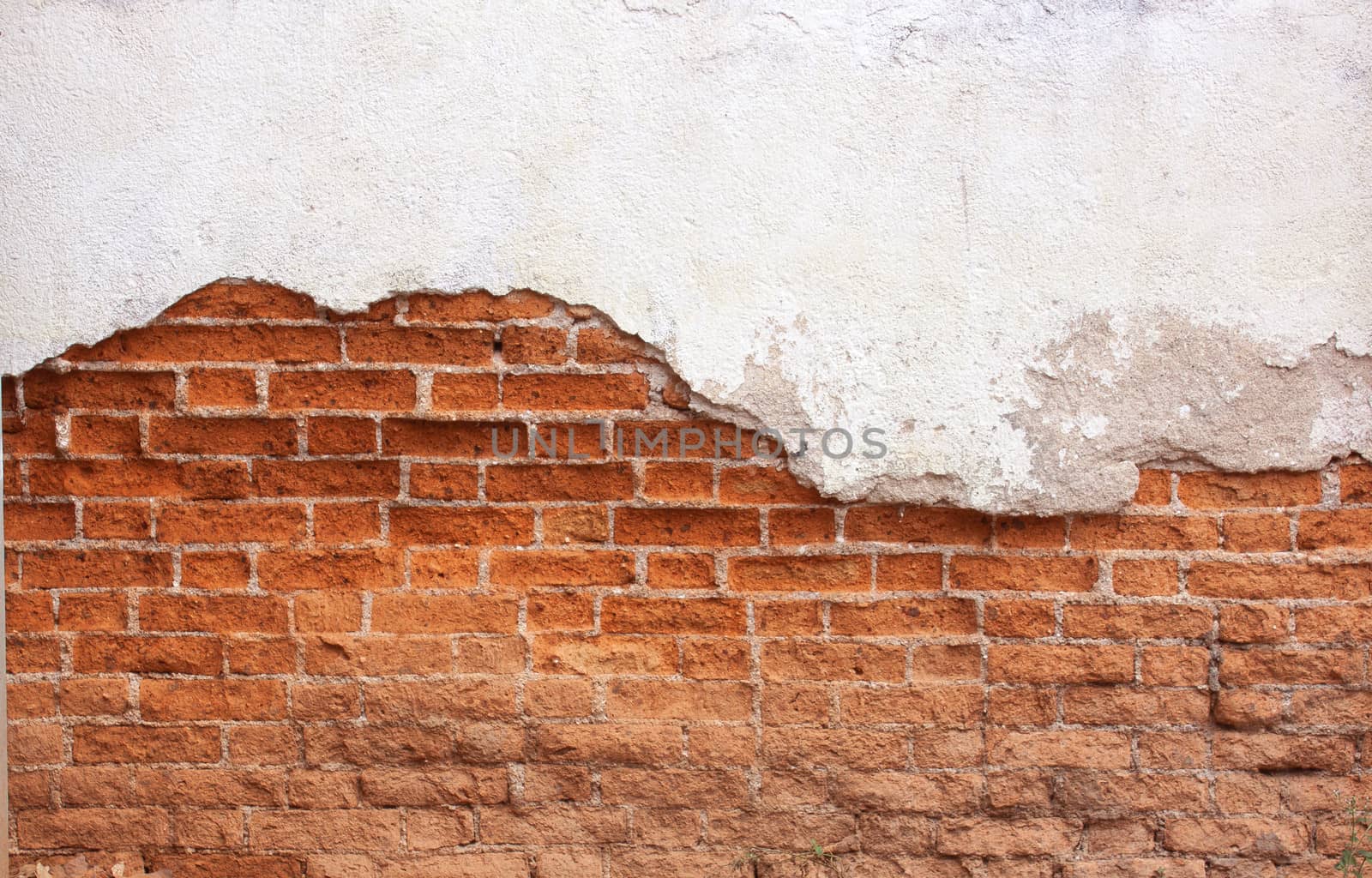 Red brick wall Old cracked concrete vintage brick wall background.