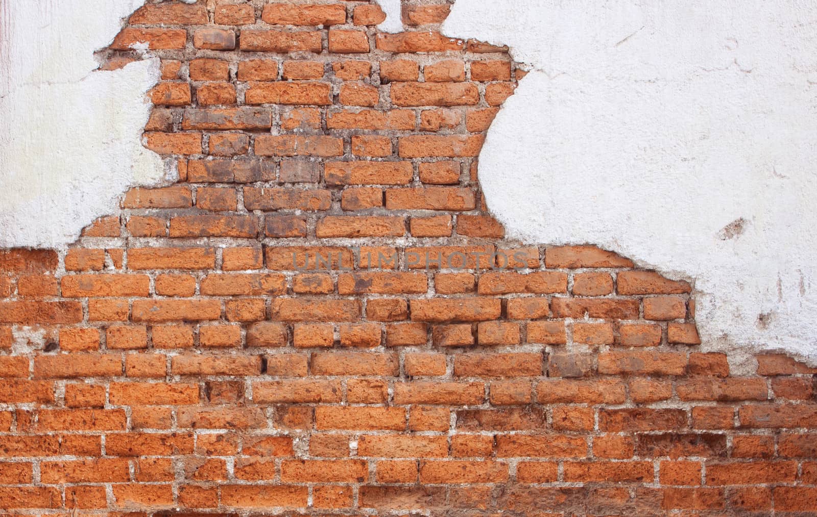 Red brick wall Old cracked concrete vintage brick wall background.