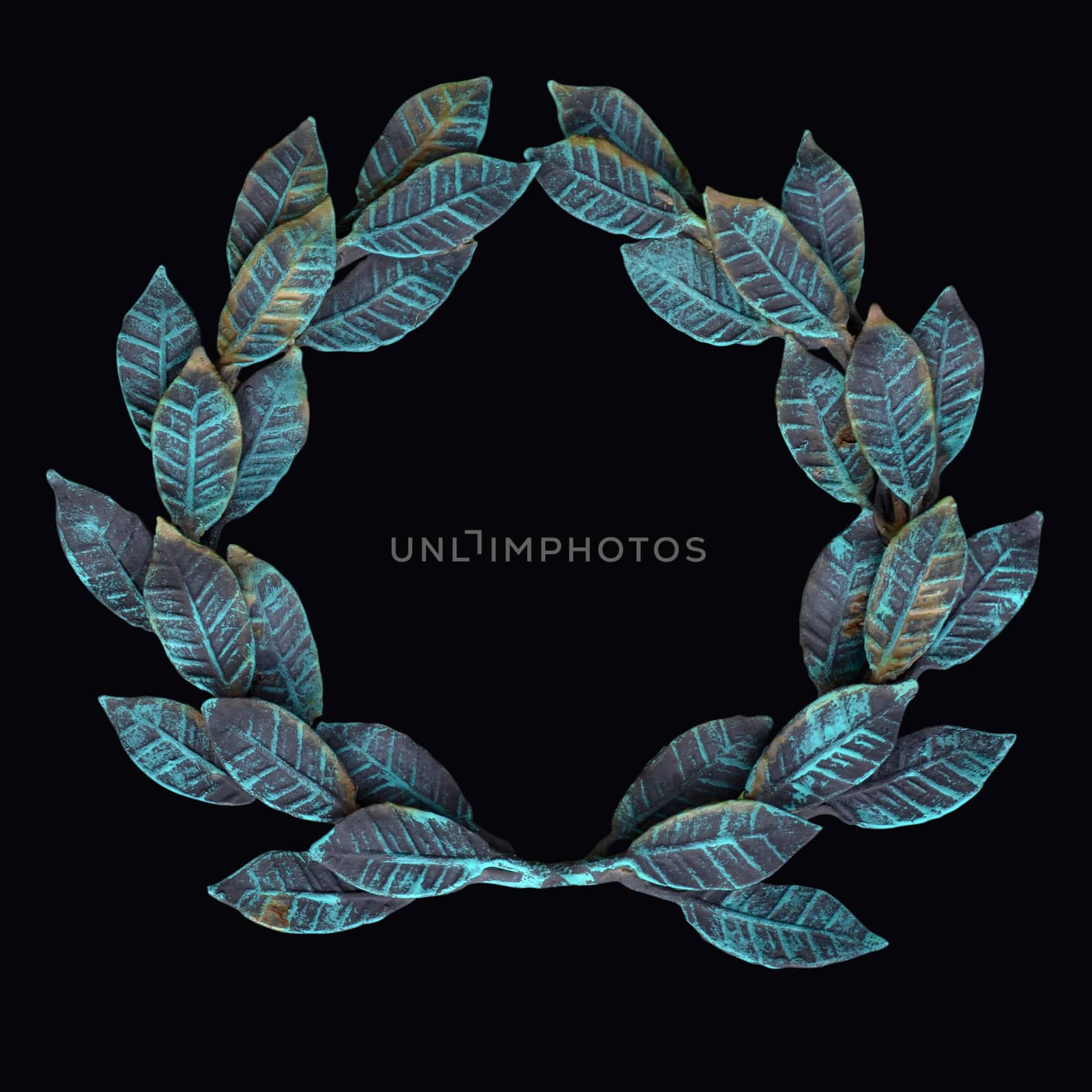 The isolate metal wreath of forged leaves with patina and rust on a black background
