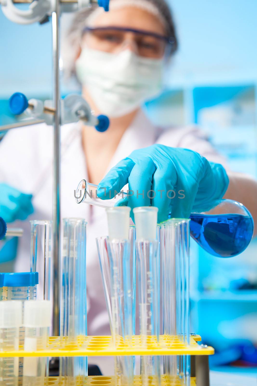 Scientific researcher holding at a liquid solution in a lab