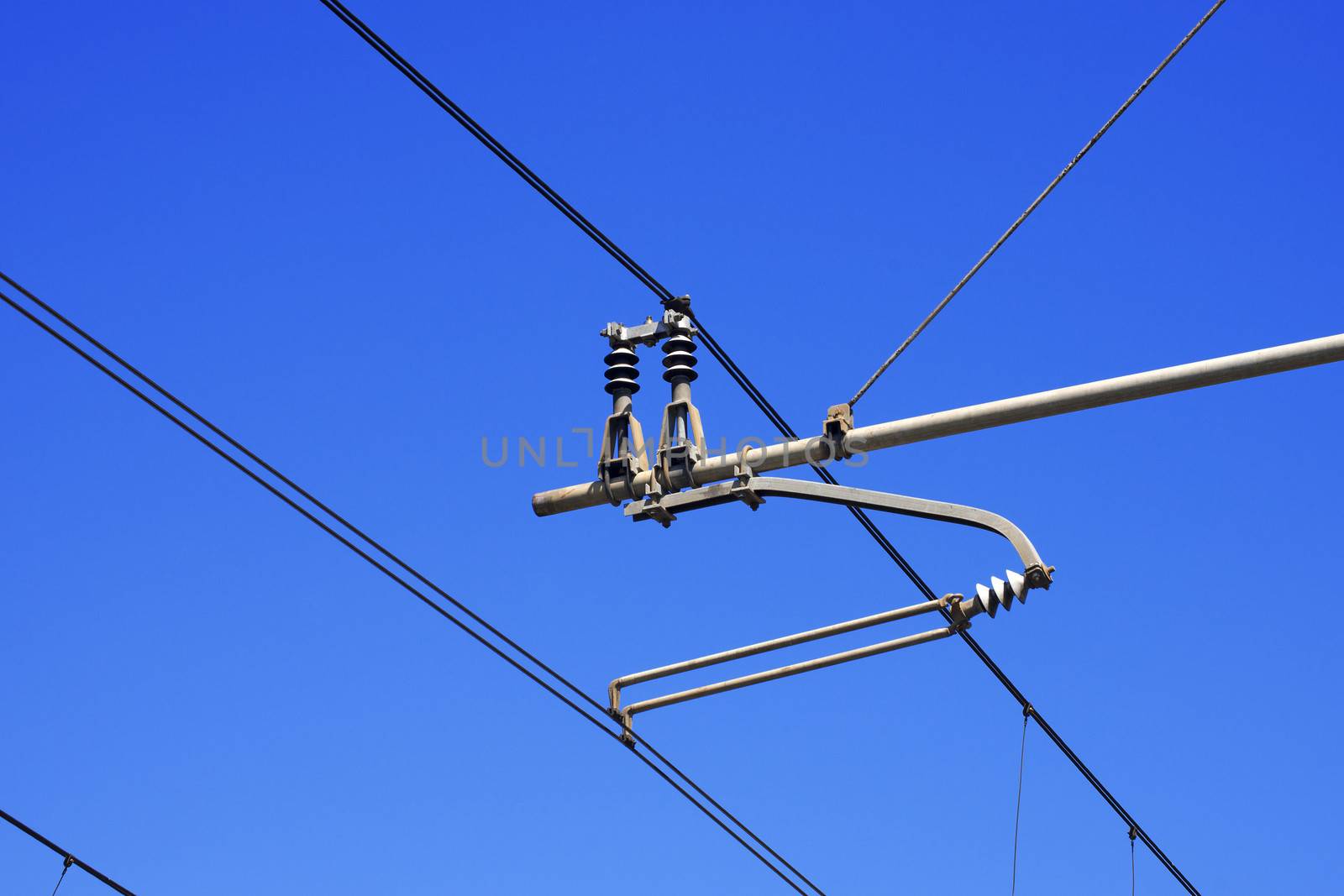 Railroad overhead lines against clear blue sky