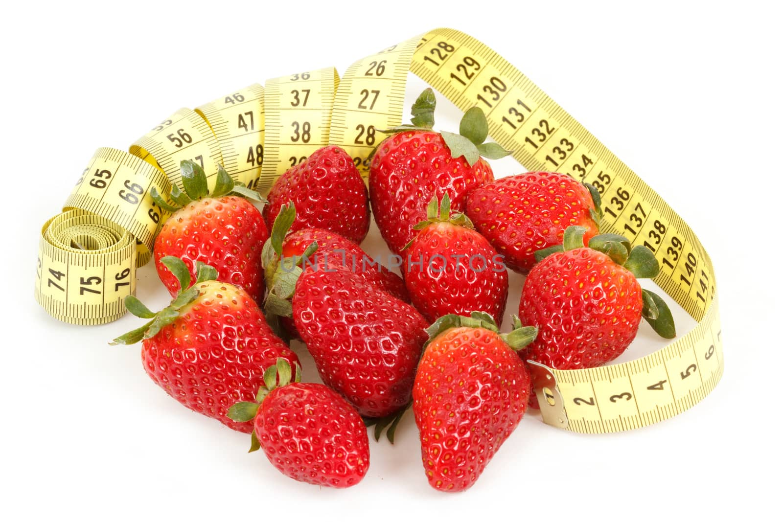 Yellow measuring tape around a strawberry as a symbol of diet