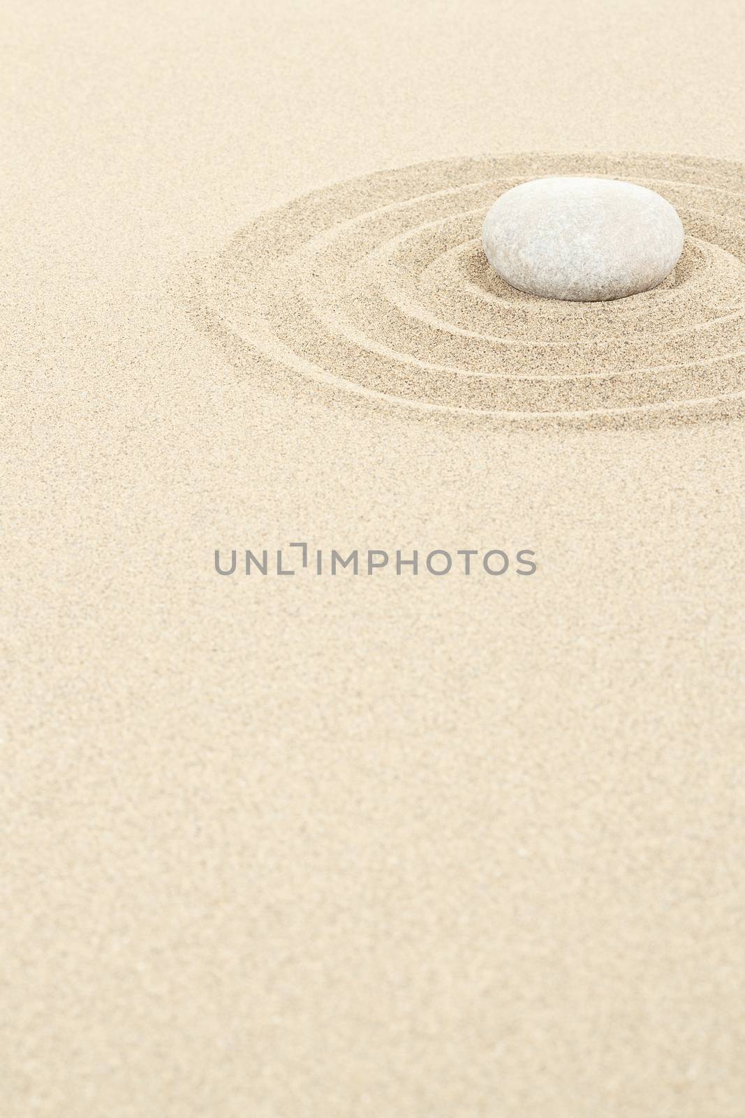 zen stones in soft sand with circles