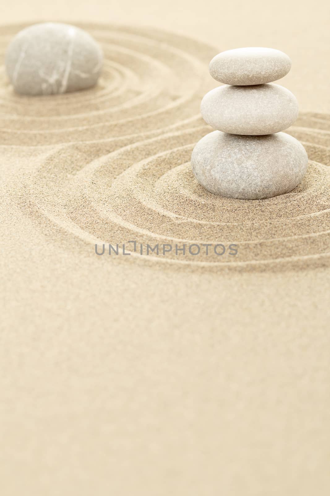Balance of three zen stones in sand 