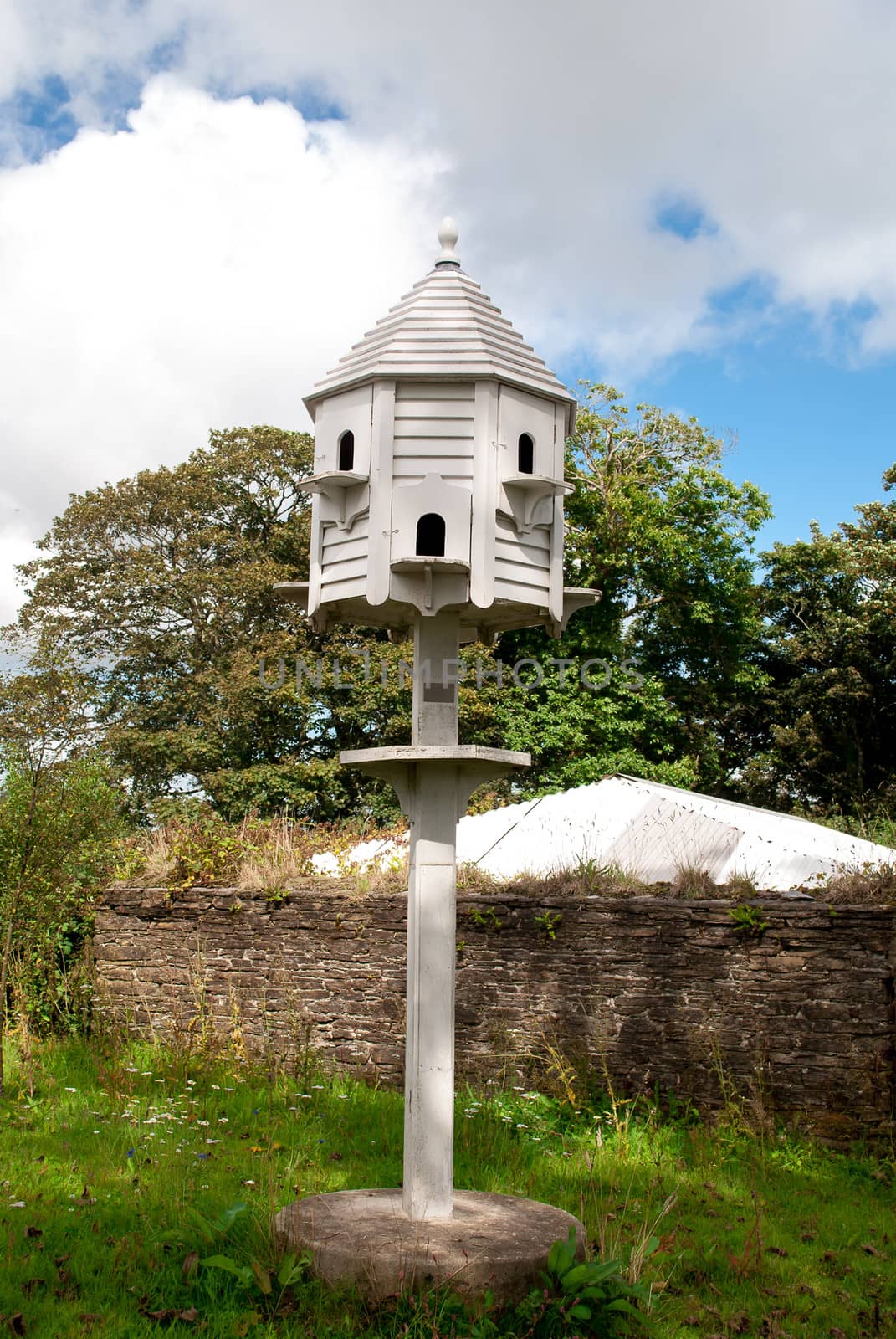 Image of a white dovecote in the country side.