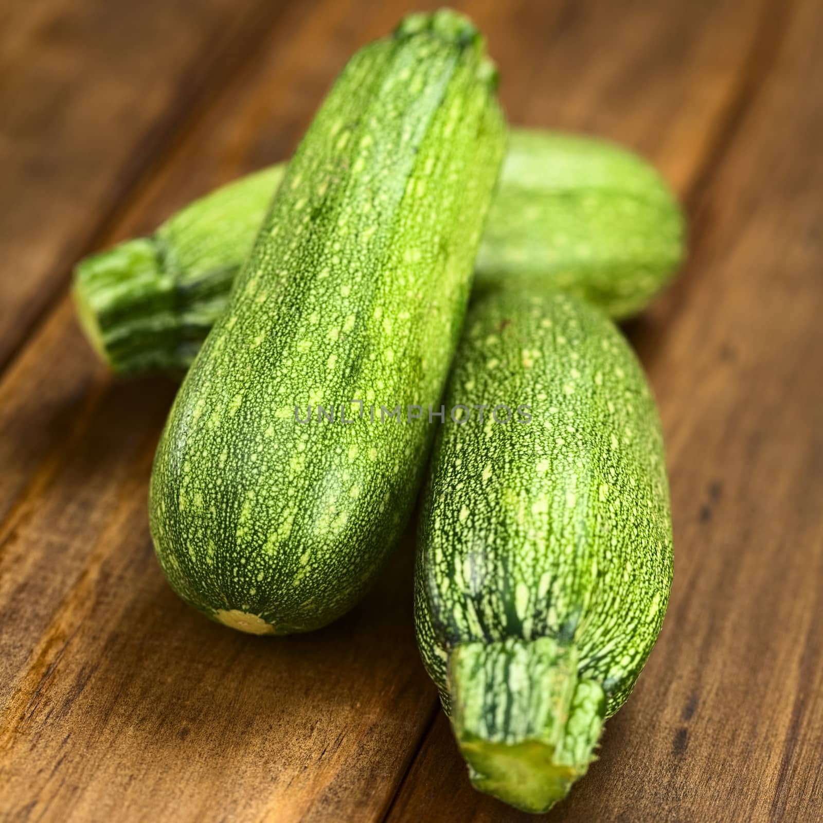 Raw zucchini on dark wood (Selective Focus, Focus one third into the image)