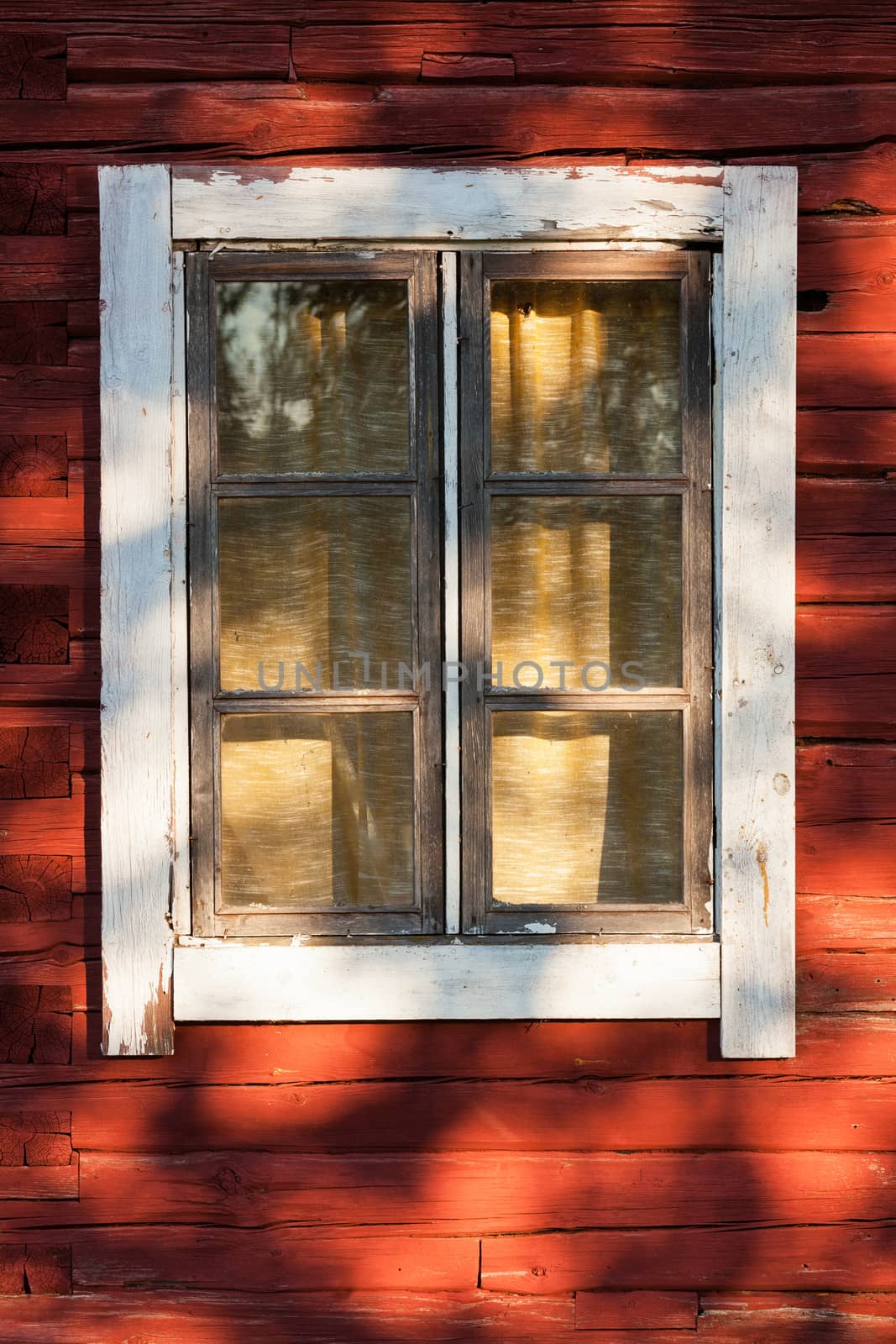 Old window in red wooden house by juhku