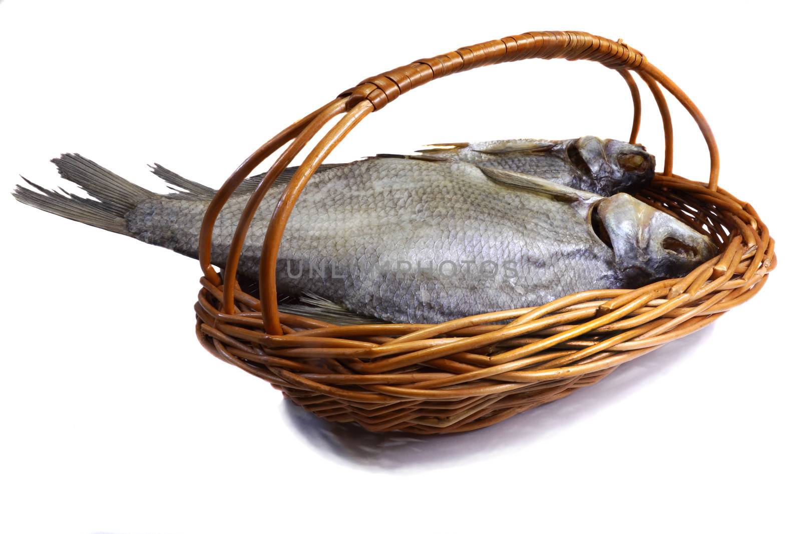 Salted and dried fish river in a basket on a white background. by georgina198