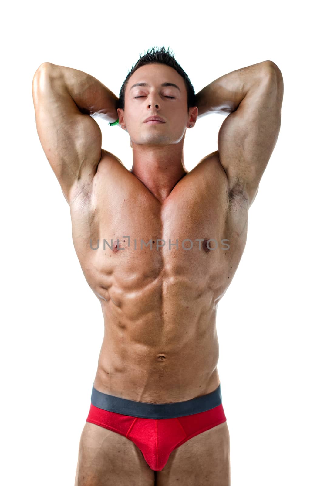 Handsome young muscle man naked with eyes closed and hands behind his head, isolated