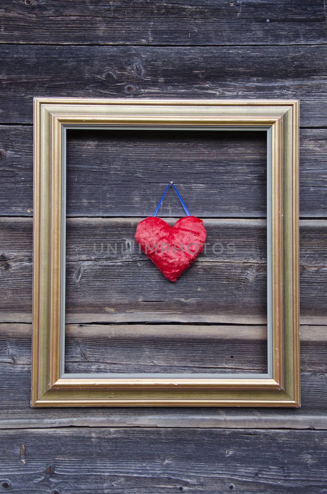 golden picture frame on old wooden wall and heart by alis_photo