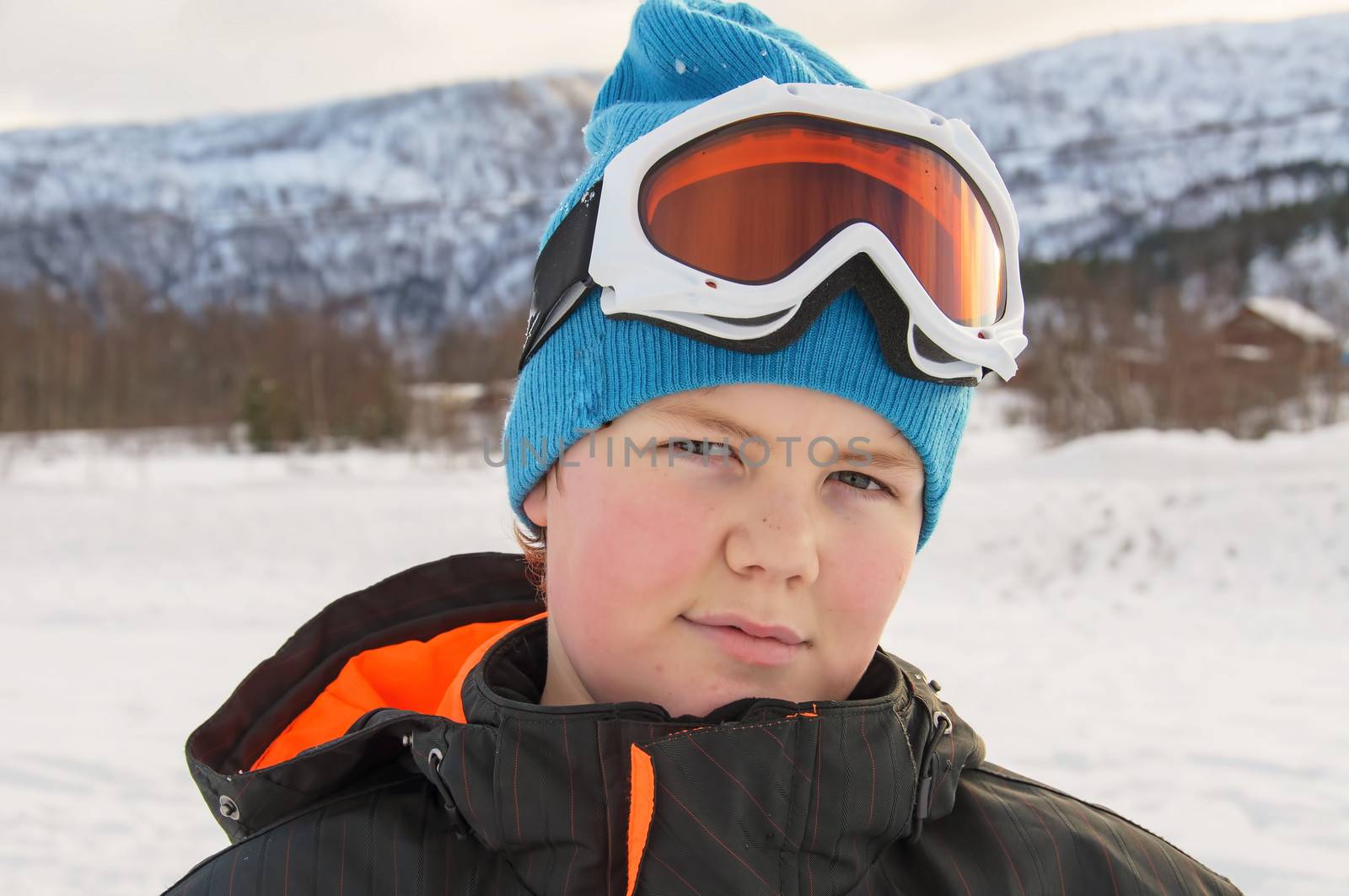 A happy young boy ready to ski/snowboard