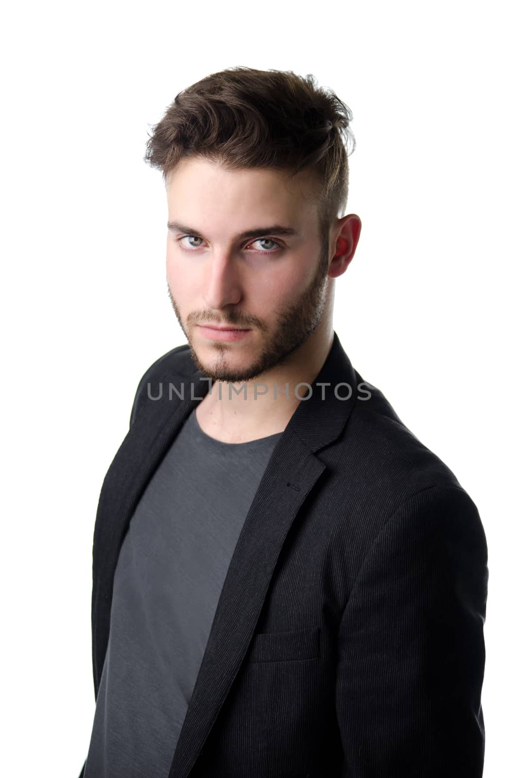 Attractive young business man looking in camera, serious expression, isolated on white