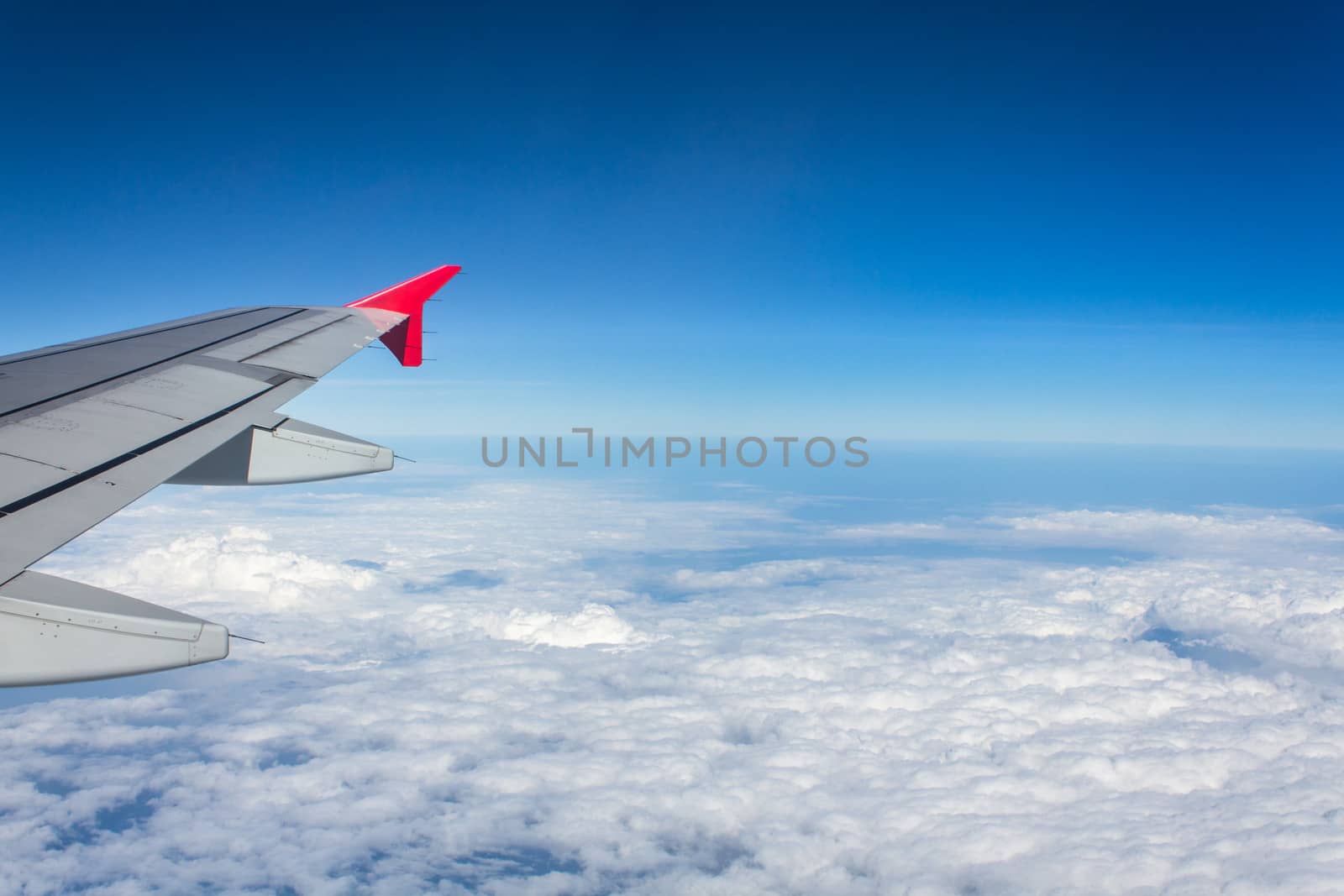 Airplane wing above the clouds by dontpoke