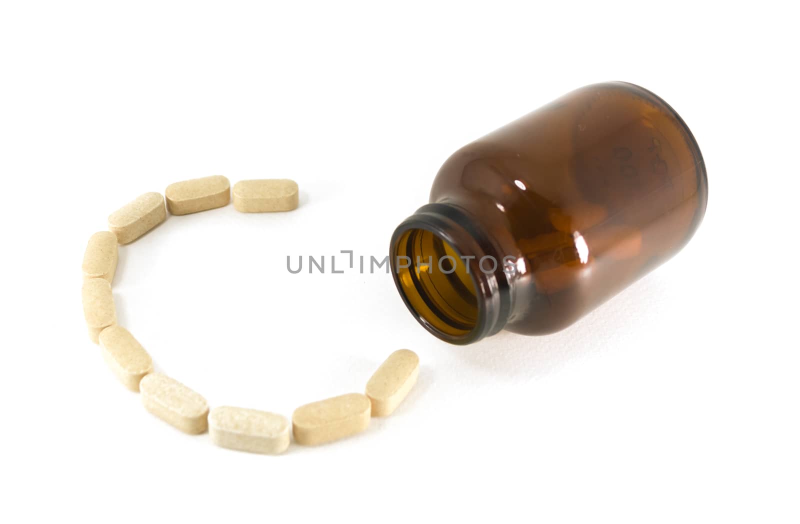 Pills of vitamin C in shape with bottle isolated on white background