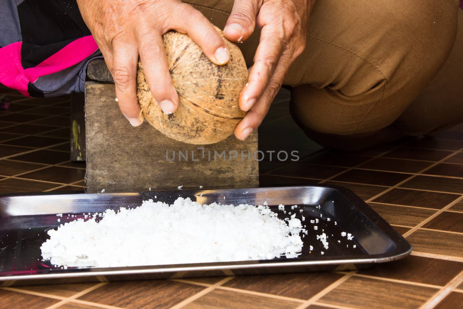 Native woman grating coconut