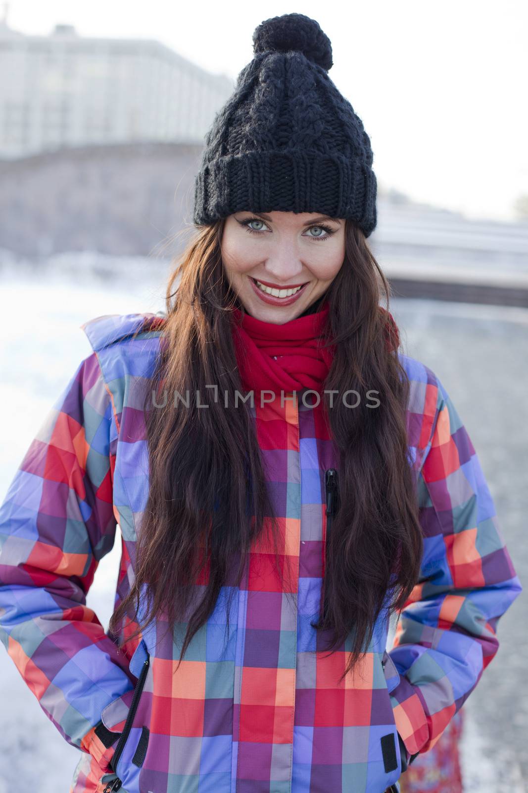 Portrait of a young woman on the background of a winter city