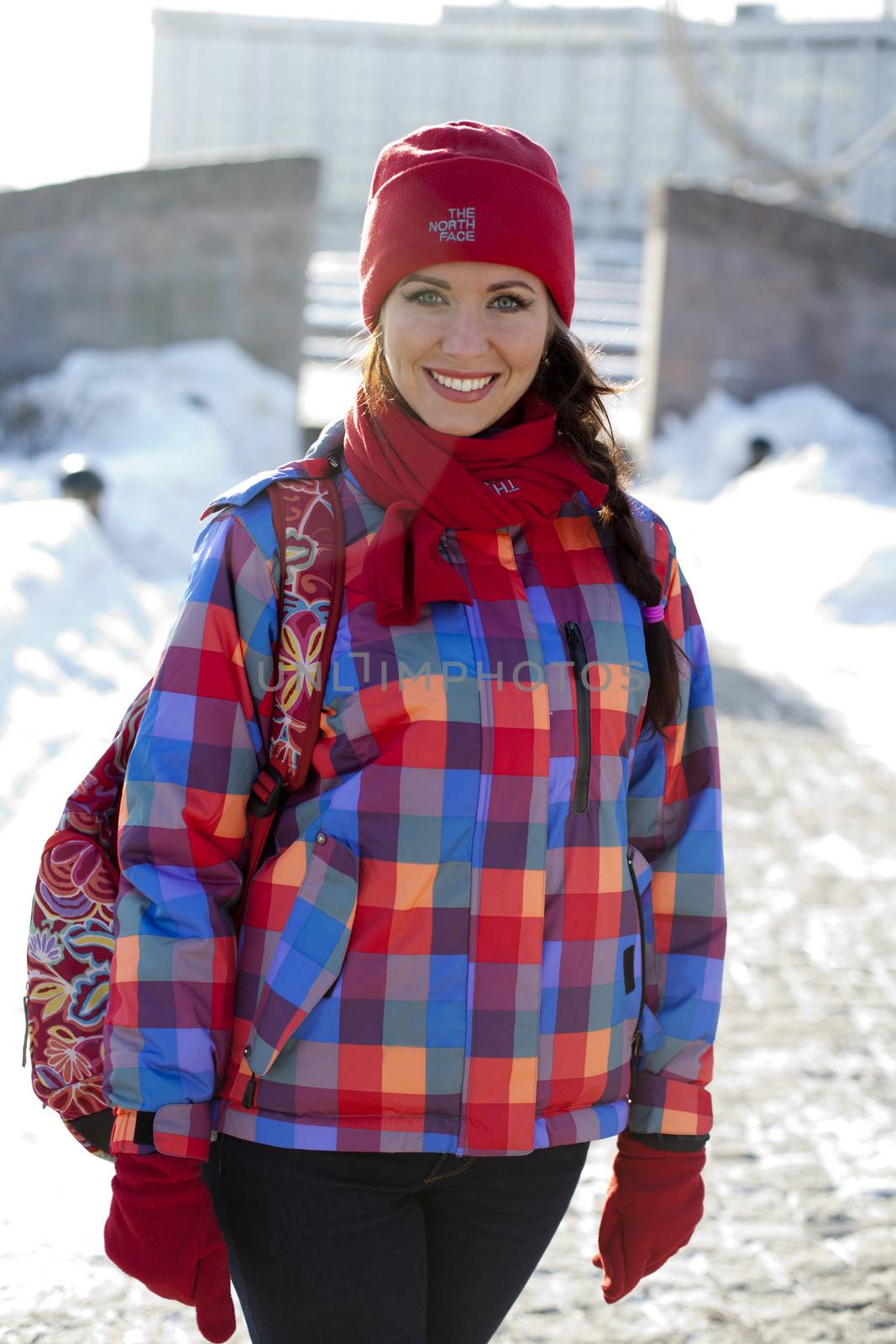 Portrait of a young woman on the background of a winter city