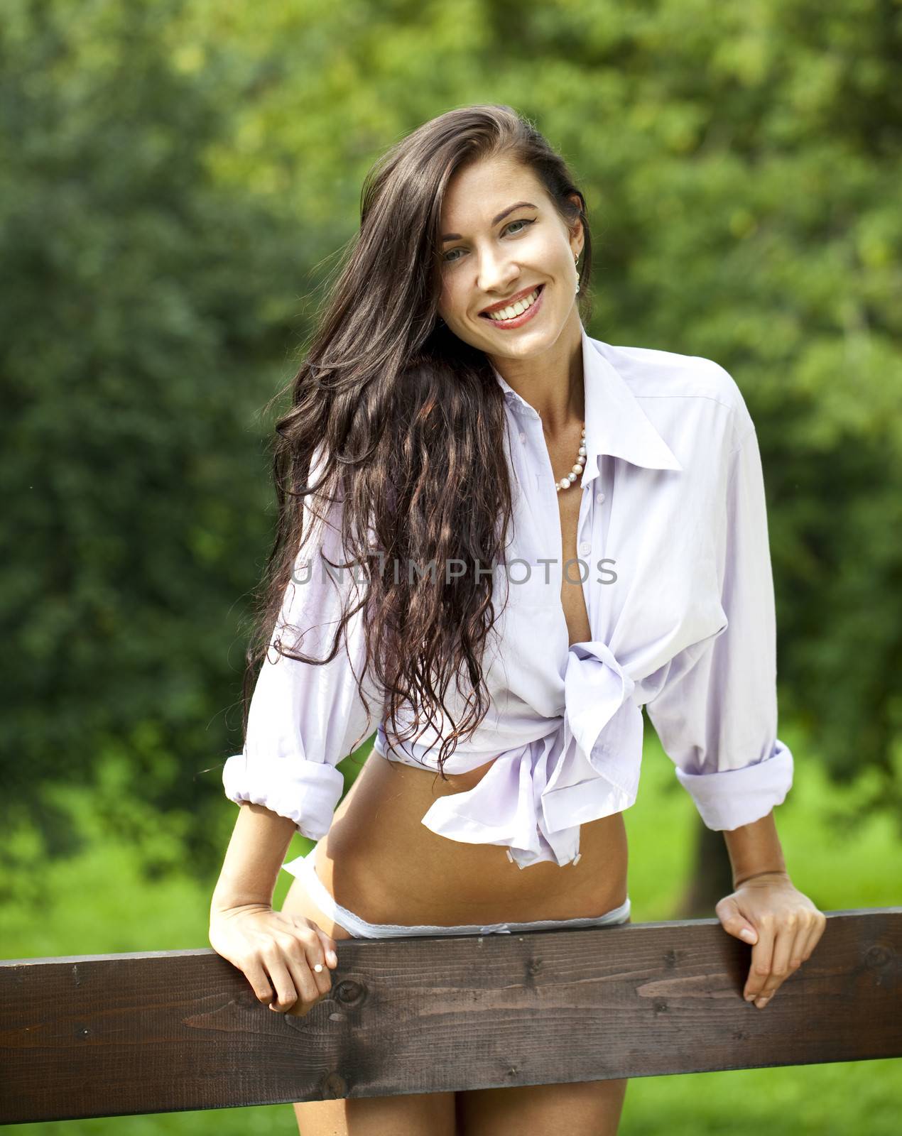 Sexy young Brunette in a summer park