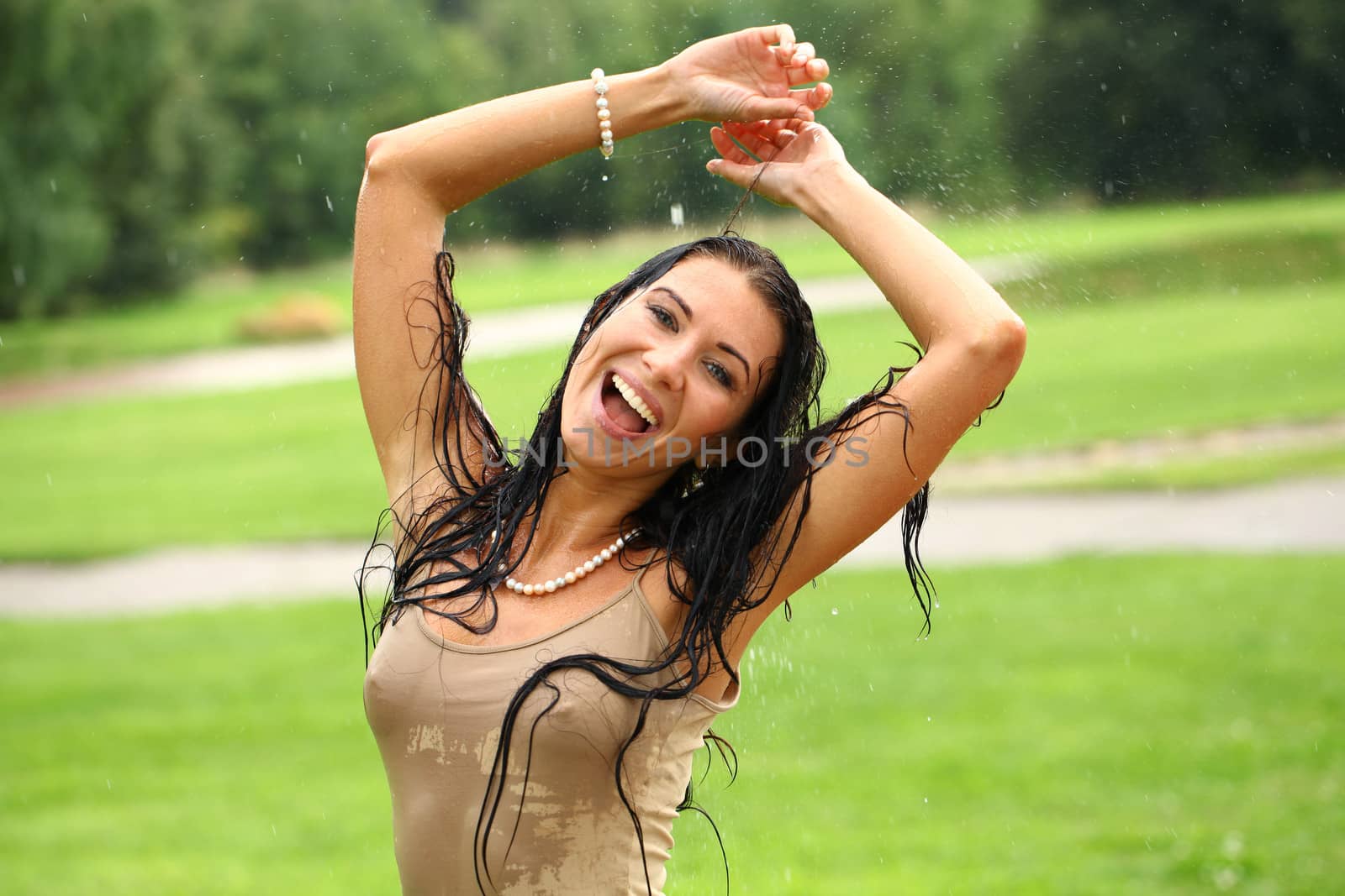 Young happy woman walking in the rain