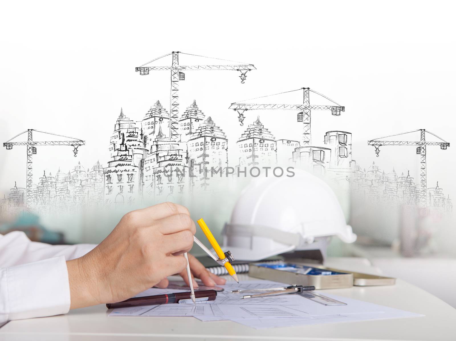 architect working on talbe with sketching and building construction for multipurpose
