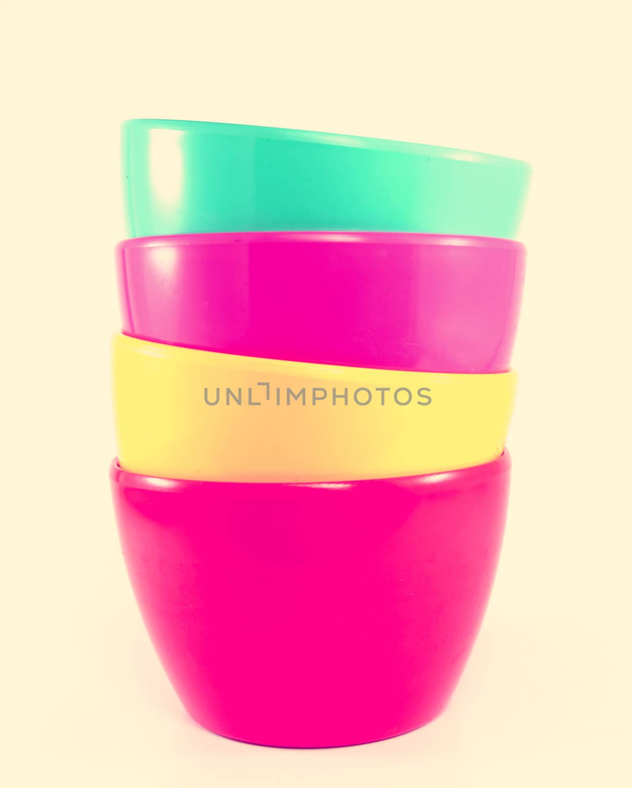 Stack of colorful plastic bowl with retro filter effect by nuchylee