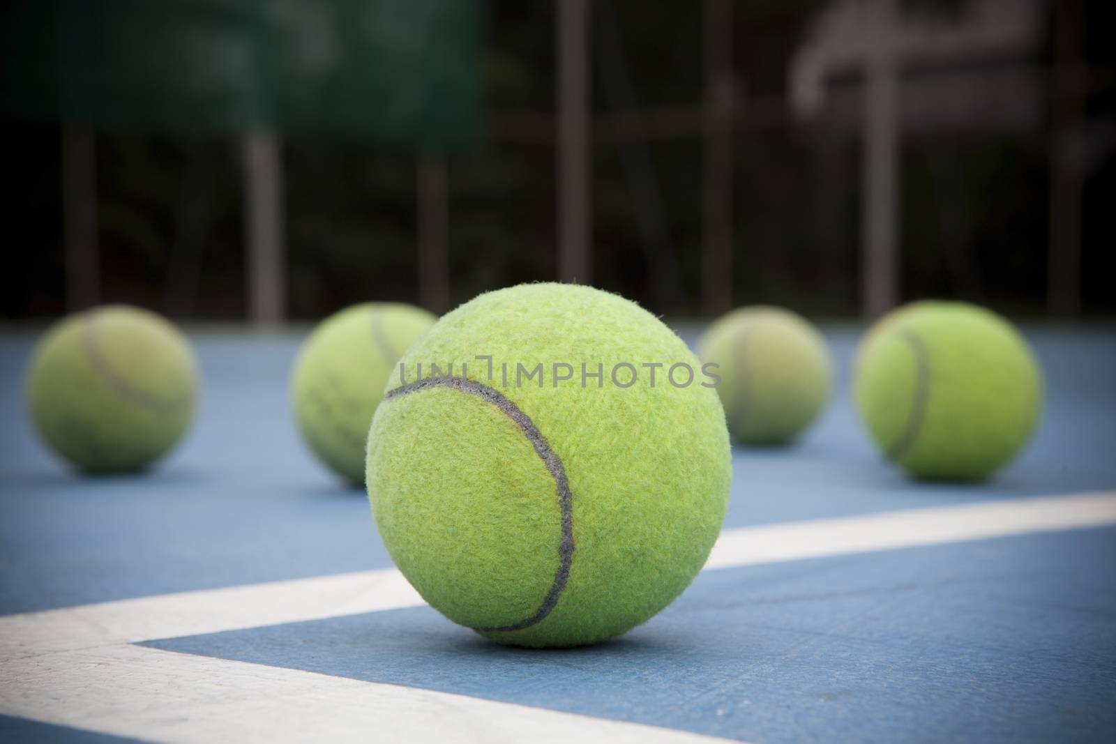 tennis ball on court field by khunaspix