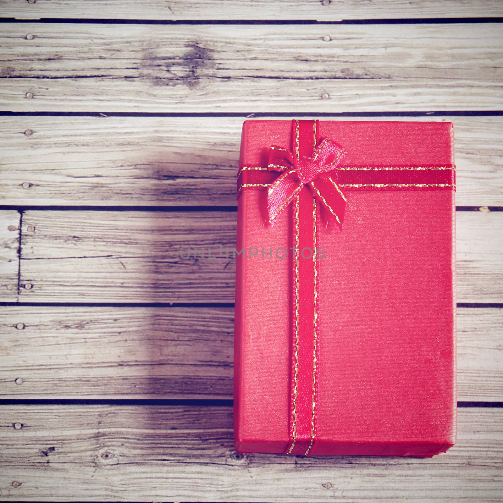 Red present box with retro filter effect by nuchylee