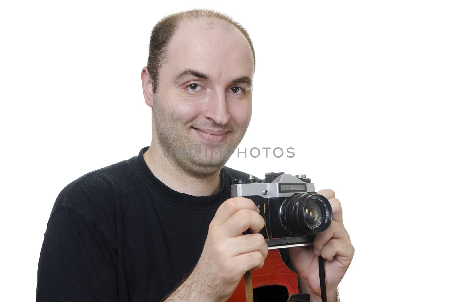 portrait of a young man holding a vintage camera on white background