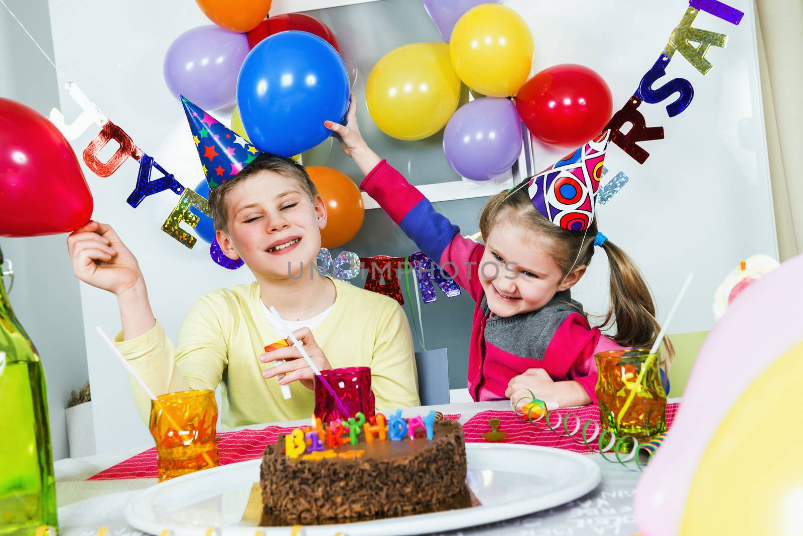 Happy little children are having fun in a birthday party 