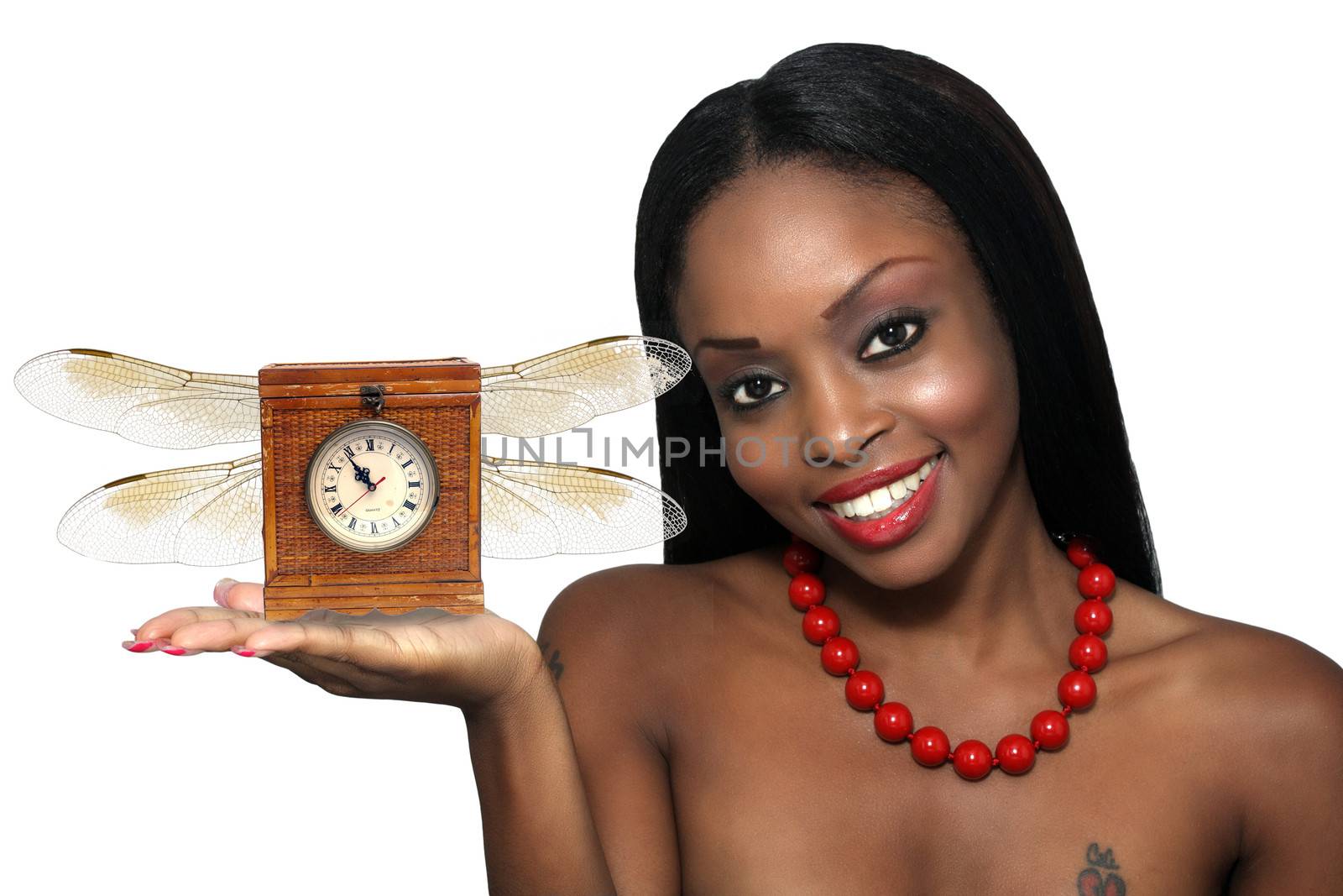 Studio close-up of an extraordinarily beautiful young woman with a bright, warm smile and an antique clock with wings in her extended hand.