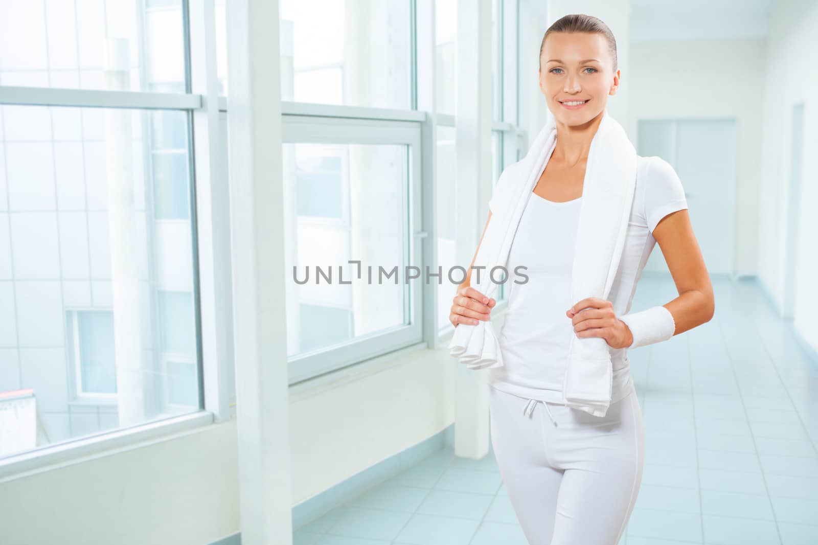 a sportswoman in white clocthes with cotton towel