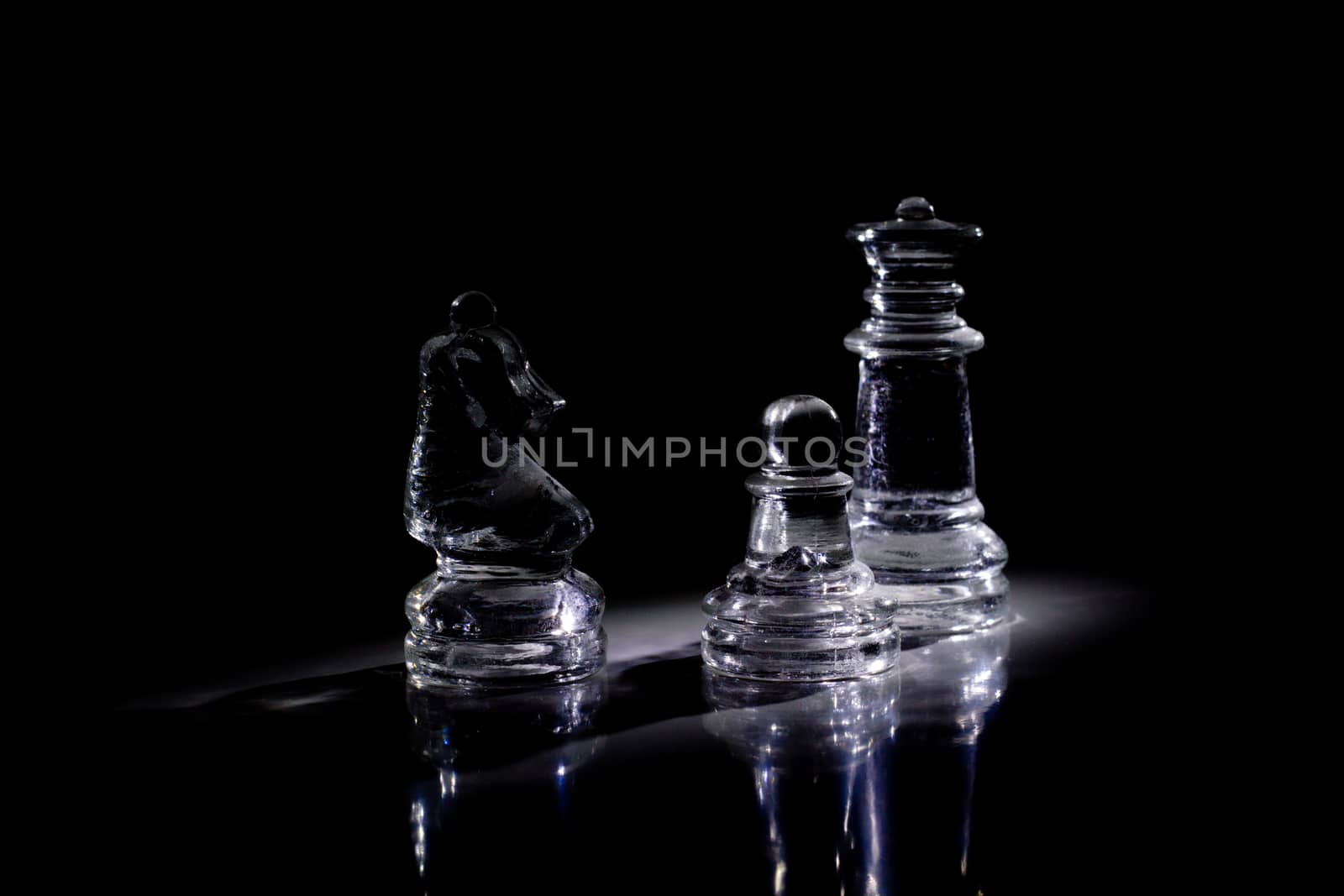 Some chess pieces in the darkness