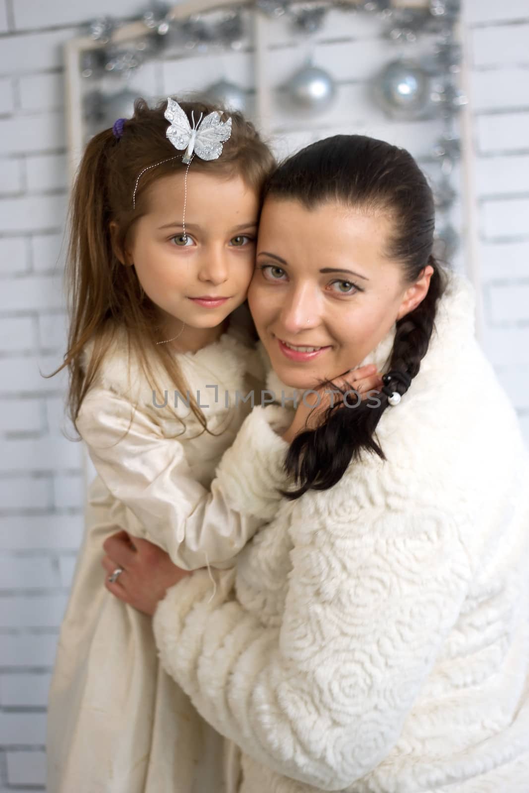 Mom and daughter in the winter holidays New Year and Christmas dresses