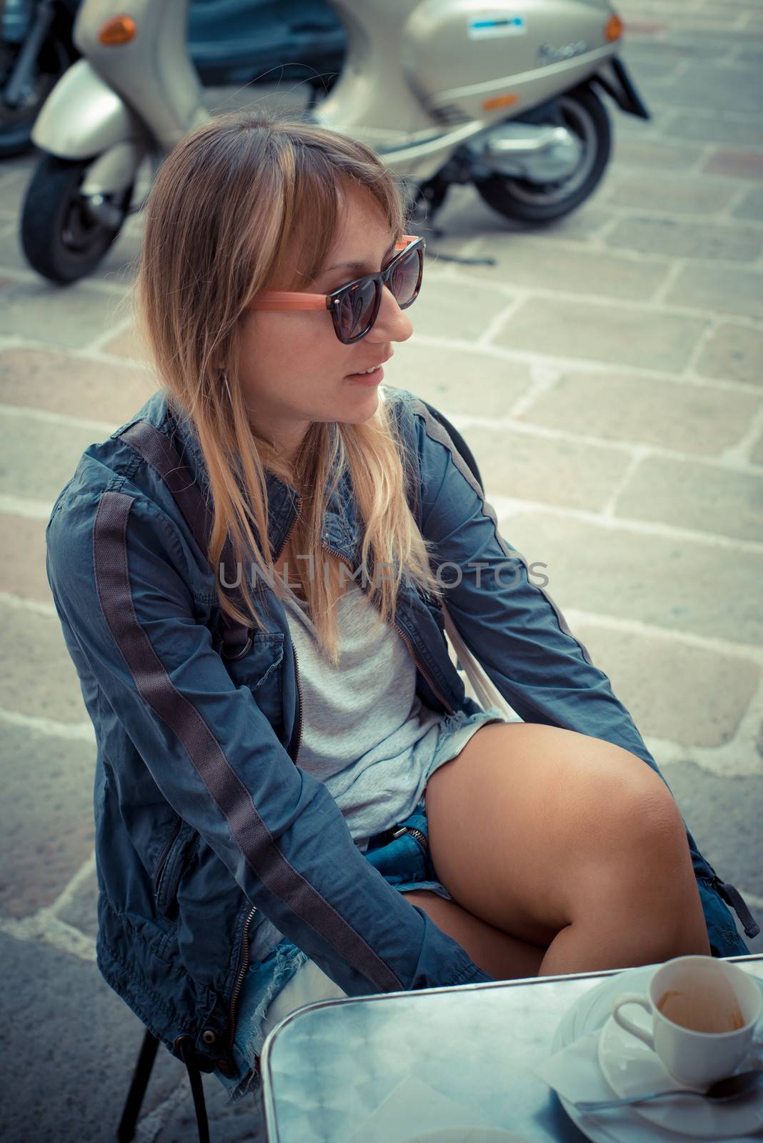 beautiful blonde woman having breakfast at the bar in the city