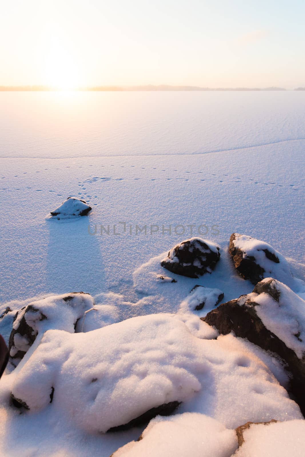 Serene winter morning view to frozen lake by juhku