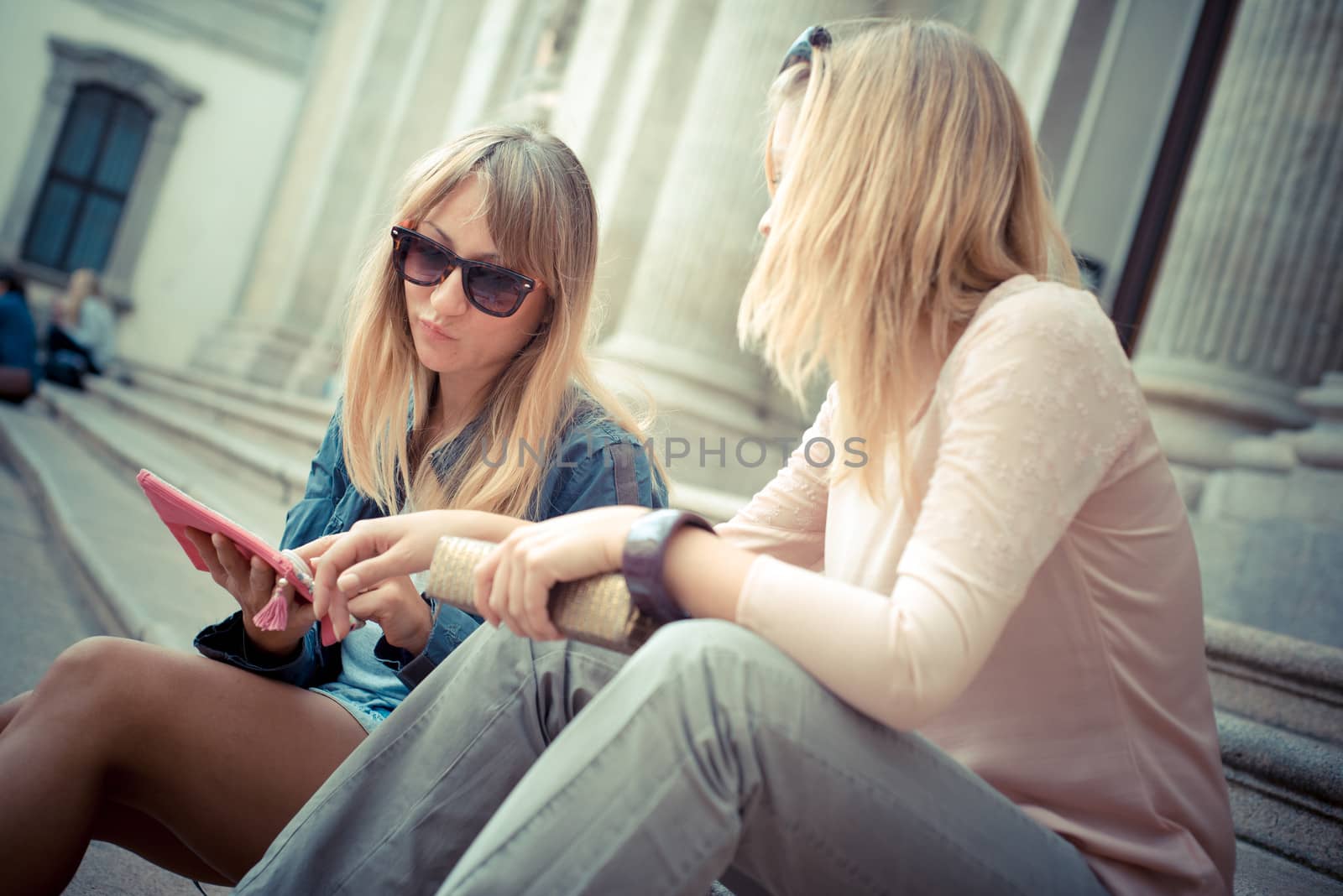 two beautiful blonde women talking  by peus