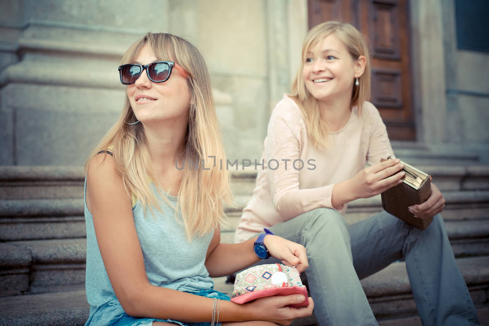 two beautiful blonde women talking in the city