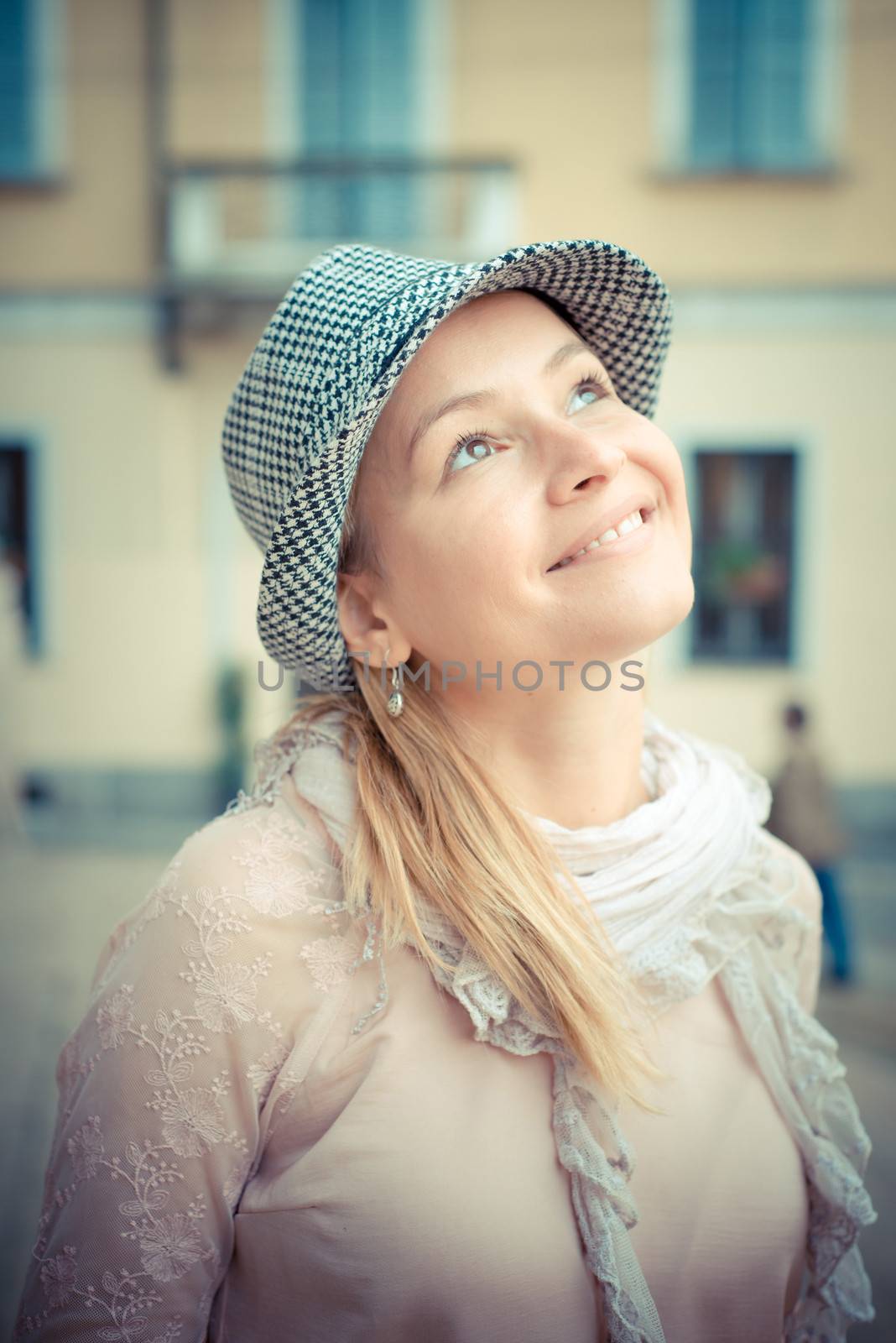 beautiful blonde woman with hat in the city