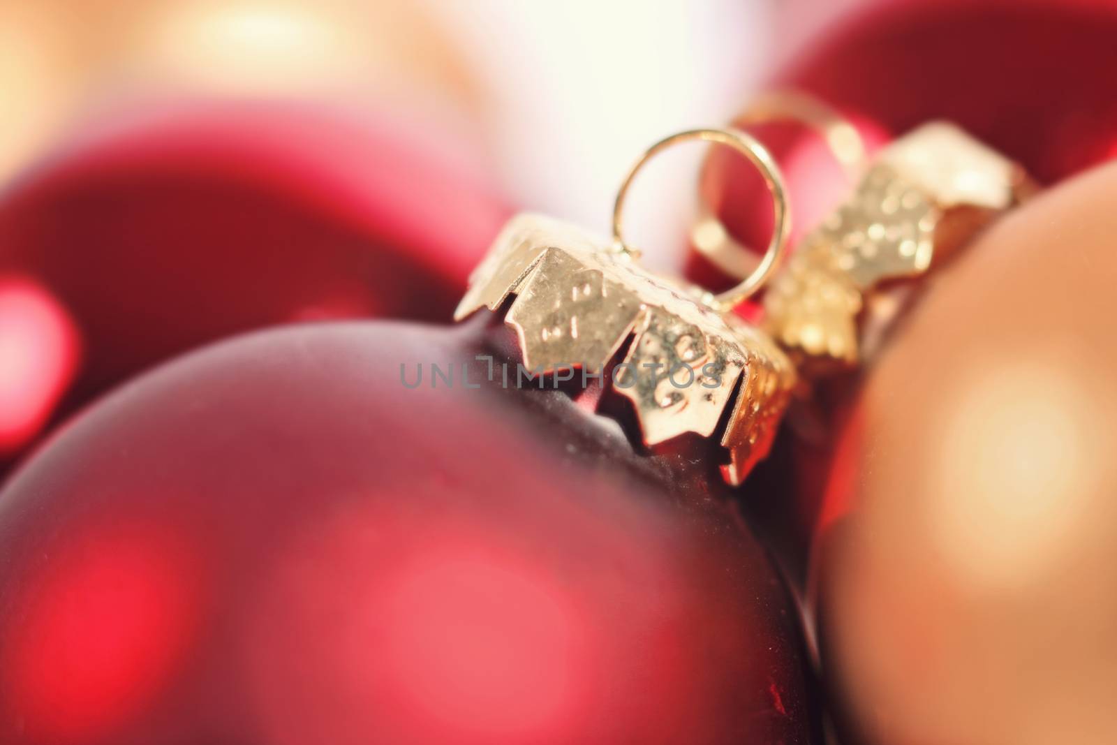 A close-up of red and gold Christmas ornaments