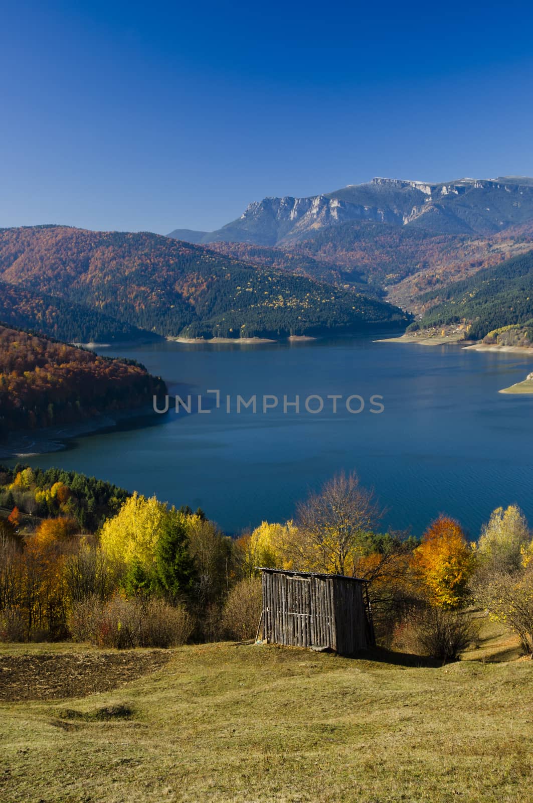 Autumn rural mountain landscape with lake, Romanian Carpathians