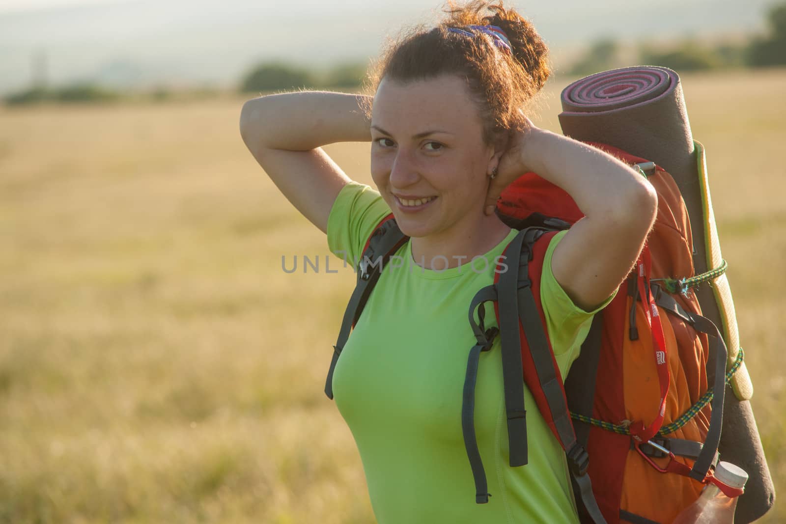 Happy smiling woman in field by kozak