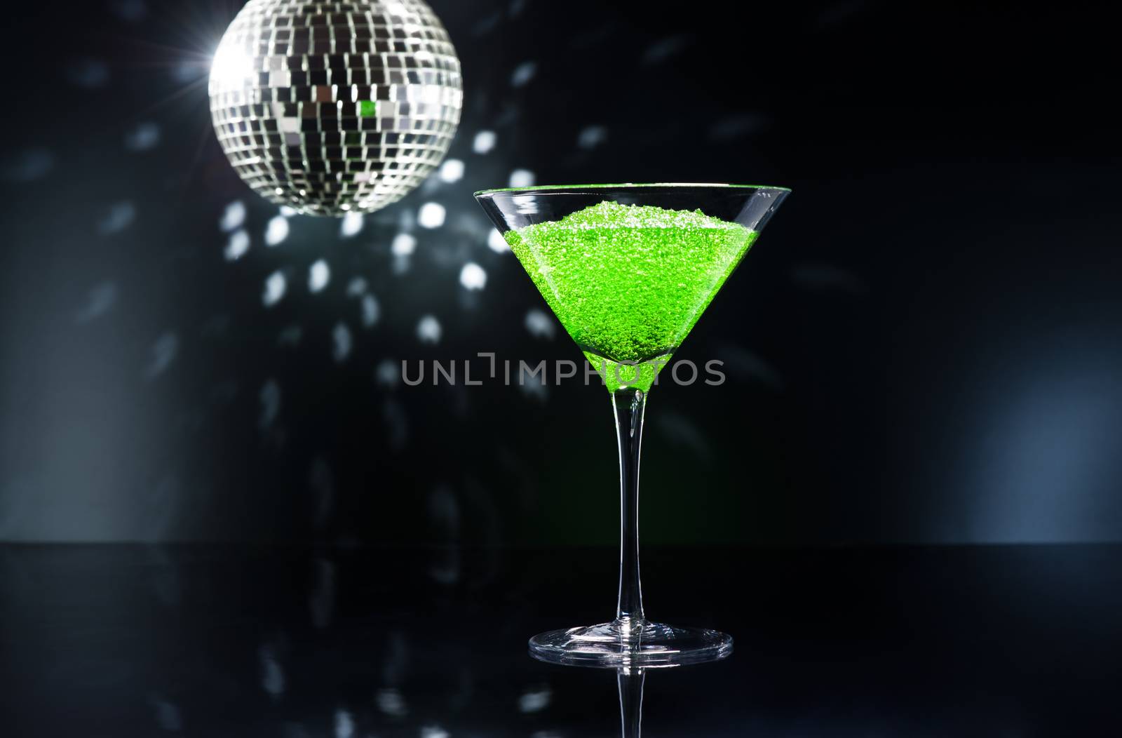 Apple Martini cocktail in front of disco lights