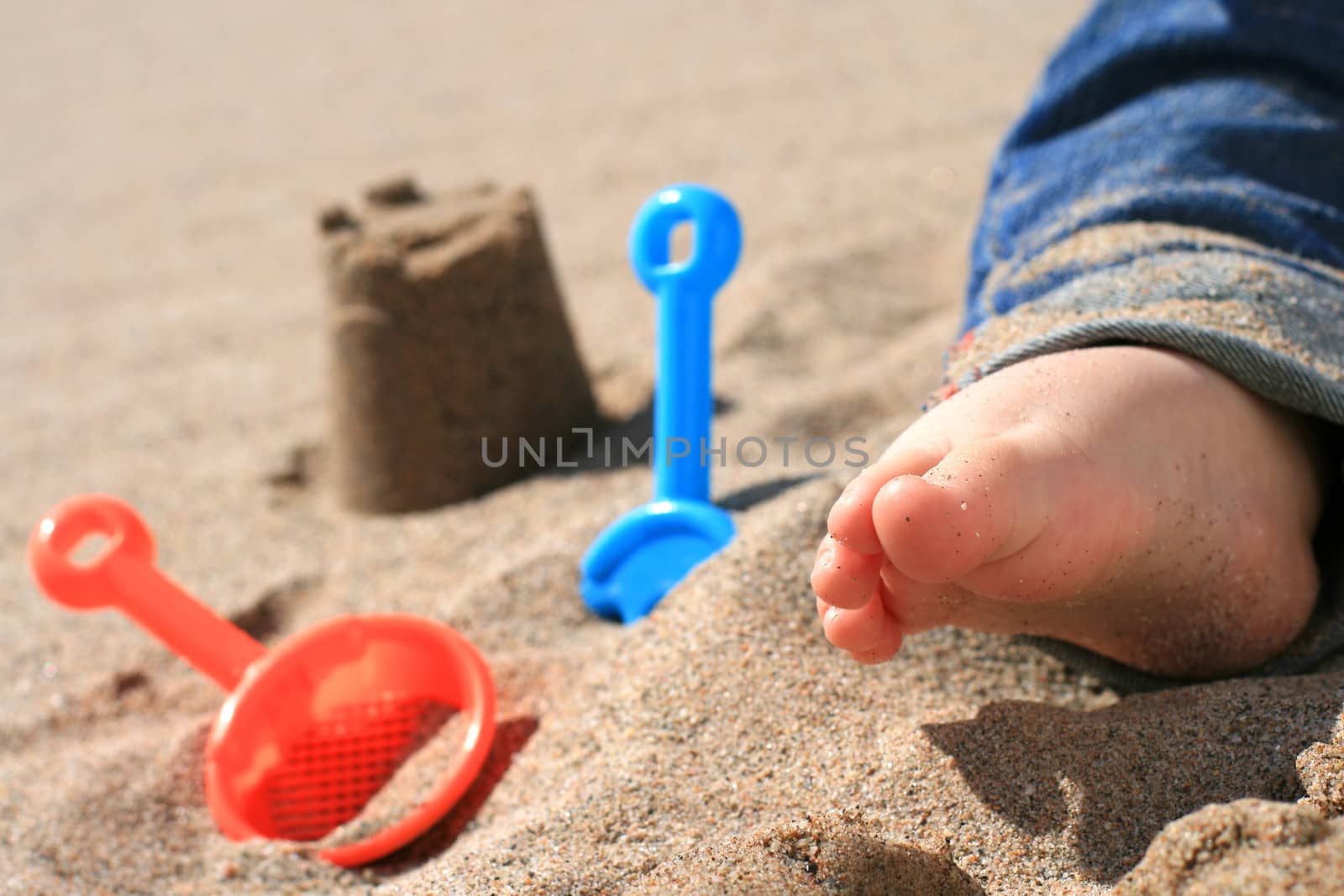 Baby playing on the beach.