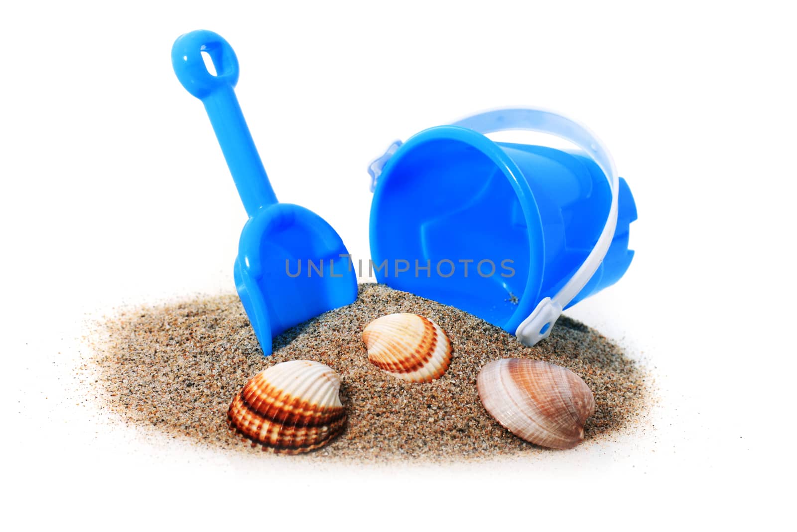 Toys and sand isolated over white.